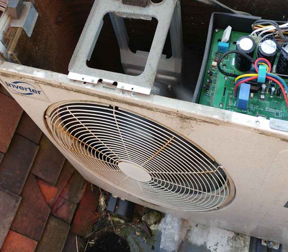 Inside of old air conditioning unit that is getting repaired
